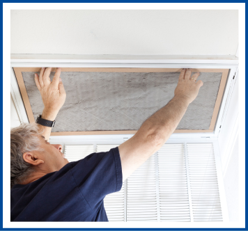 man putting in new air filter