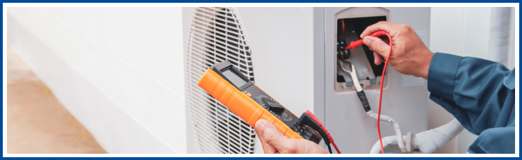 worker performing maintenance on a ductless unit